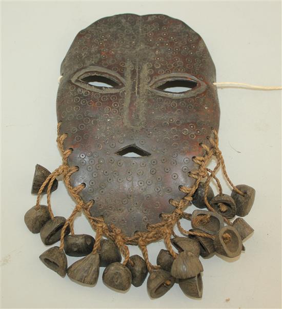 A tribal carved bone mask, 8.5in.